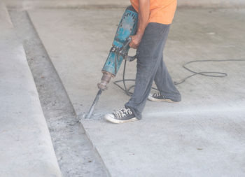 Low section of man walking on street