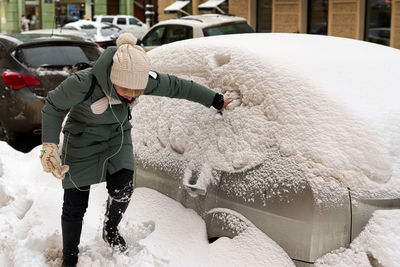 Rear view of man standing in snow