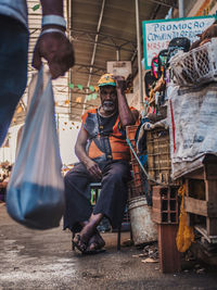 Men sitting on street in city