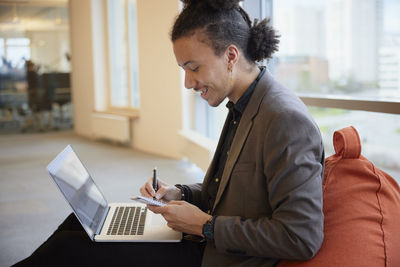 Man in office using laptop