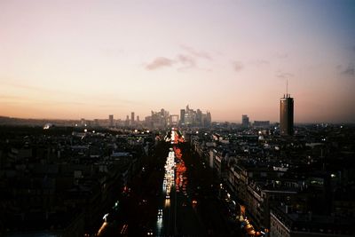 High angle view of illuminated cityscape against sky at sunset