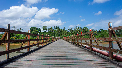 Surface level of footbridge against sky