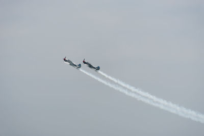 Low angle view of airplane flying against sky