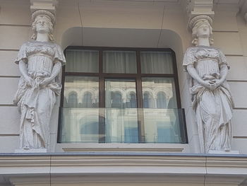 Low angle view of statue against building