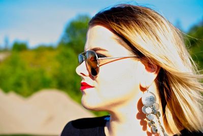 Close-up of woman wearing sunglasses on sunny day