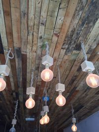 Low angle view of illuminated chandelier hanging from ceiling