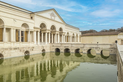 The beautiful facade of the famous palazzo te in mantua reflecting on the water