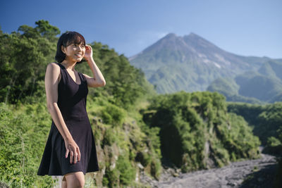 Woman standing against mountains