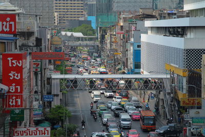 Cars on street amidst buildings in city