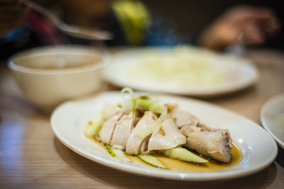 Close-up of fresh chicken served in plate on table