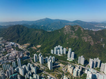 High angle view of townscape and mountains against clear sky