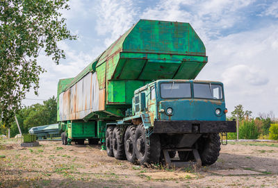 Abandoned truck on field against sky