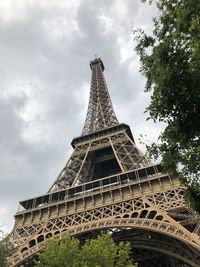 Low angle view of tower against cloudy sky