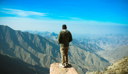 Rear view of man looking at mountains