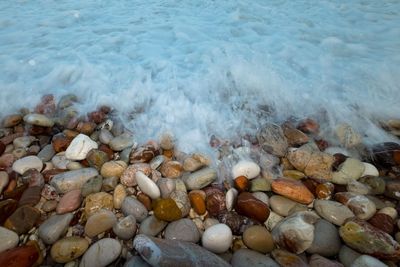 High angle view of pebbles on shore