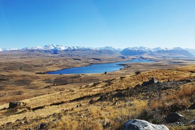 Scenic view of snowcapped mountains against clear blue sky
