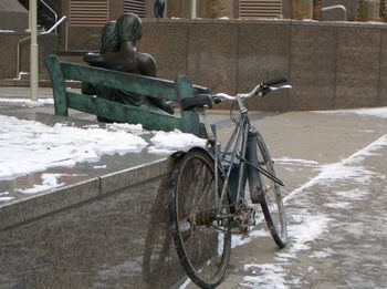 Man sitting on bench in city