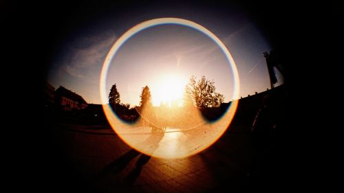 View of sun shining through car at sunset