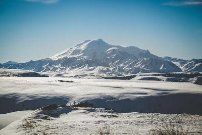 Scenic view of snowcapped mountains against sky