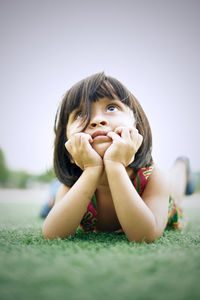 Portrait of cute girl sitting outdoors