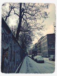 Empty road along buildings