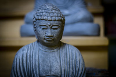 Close-up of statue against temple outside building