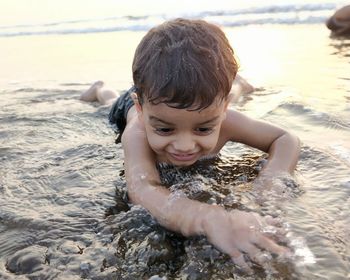 Boy lying down at beach