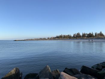 Scenic view of sea against clear blue sky