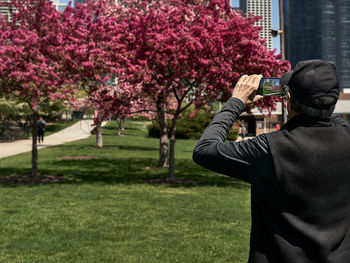 Rear view of man drinking water