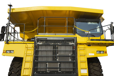 Close-up of construction machinery against white background