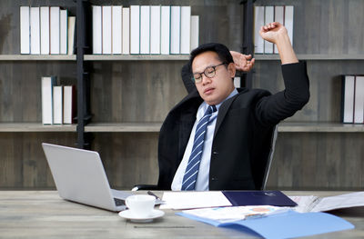 Businessman relaxing while sitting at office