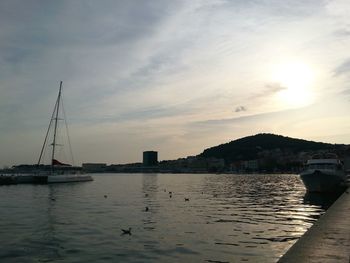 Boats in harbor at sunset