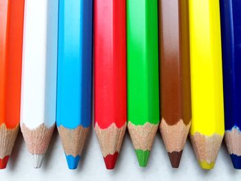 Close-up of multi colored pencils on table