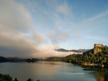 Scenic view of lake against cloudy sky