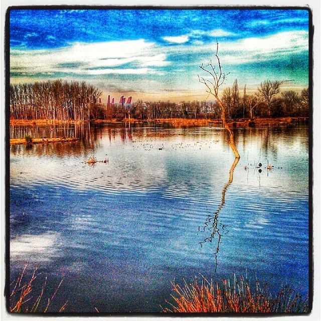 transfer print, water, auto post production filter, sky, reflection, lake, tranquility, tranquil scene, cloud - sky, waterfront, scenics, beauty in nature, tree, cloud, nature, rippled, blue, river, idyllic, outdoors