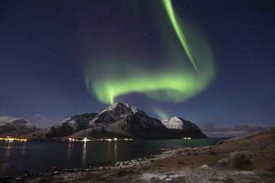 Scenic view of snowcapped mountains against sky at night