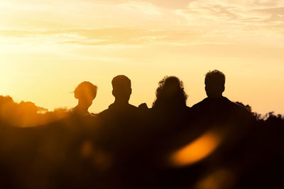 Rear view of four friends enjoying together