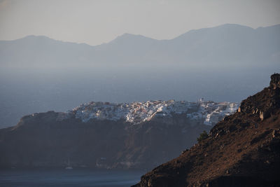 Scenic view of sea and mountains against sky