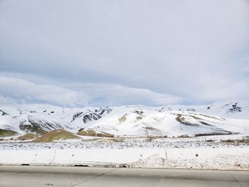 Snow covered landscape against sky