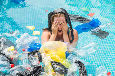 High angle portrait of woman swimming in pool