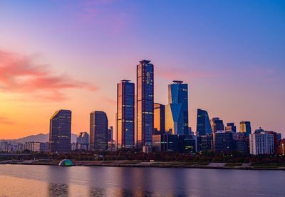 Buildings in city at sunset