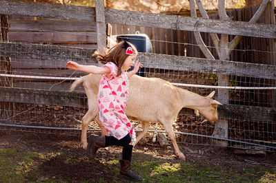 Full length of girl running at farm