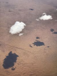 High angle view of sand on land against sky