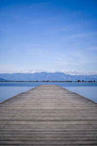 Water dock facing a lake and the mountains behind at sunset 2