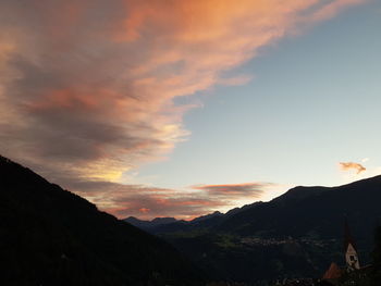 Scenic view of silhouette mountains against sky at sunset