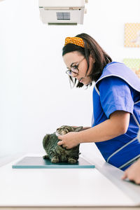 Female veterinarian examining cat at clinic