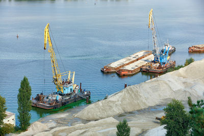 River industrial transport and equipment. floating industrial cranes load river sand .