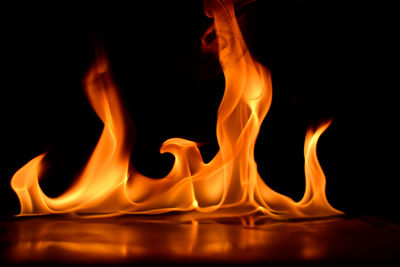Close-up of fire on table against black background