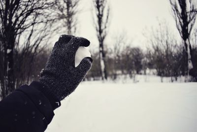 Close-up of hand holding ice cream cone during winter