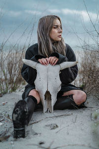 Portrait of young woman sitting outdoors